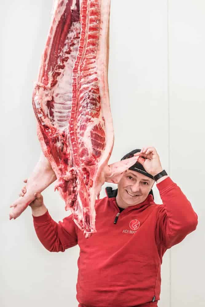 Adi Matzek mit Schweinehälfte von innen